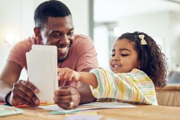 Father helping child with flashcards for sight words – Science of reading