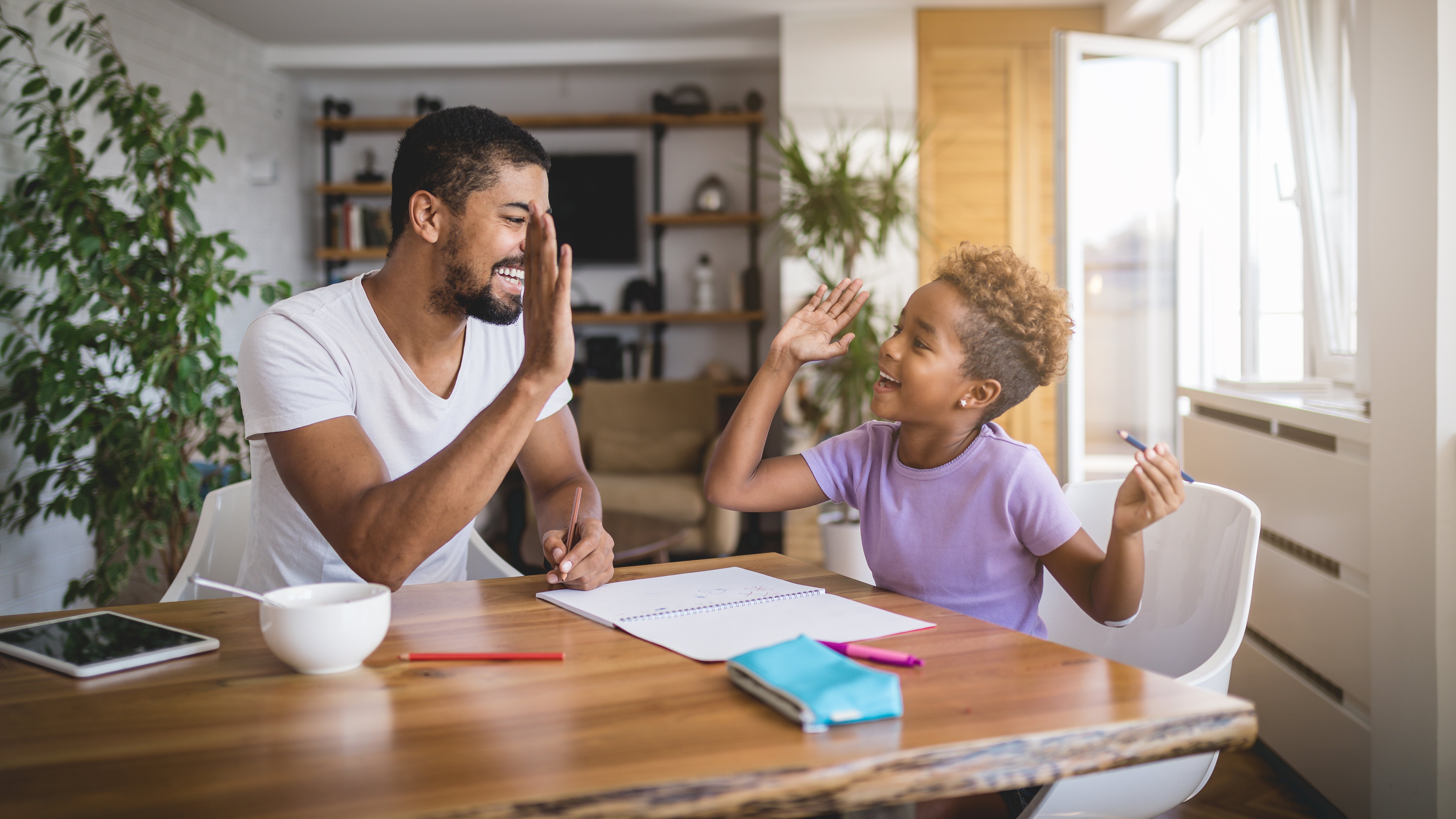 Dad with child giving high five