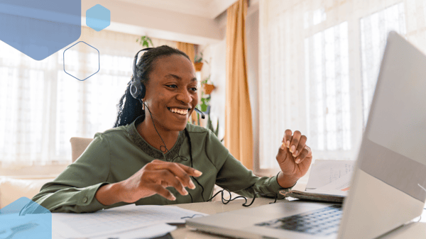 Online female tutor wearing a headset and working at a computer