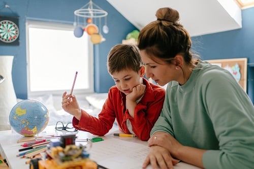 Parent helps child with homework