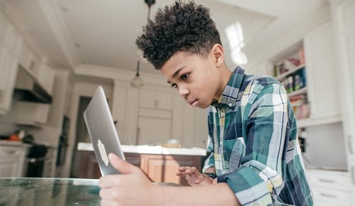 Boy working at laptop