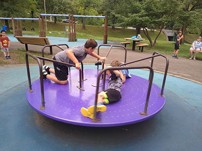 children playing on a marry-go-round at park