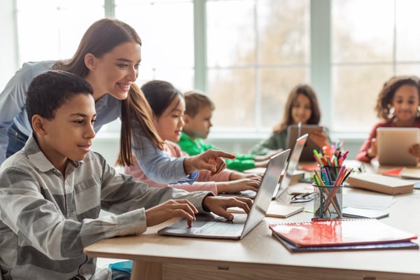 student with teacher and laptop